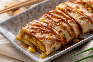 Delicious Taiwanese omelette, egg pancake roll with ham and corn kernels.