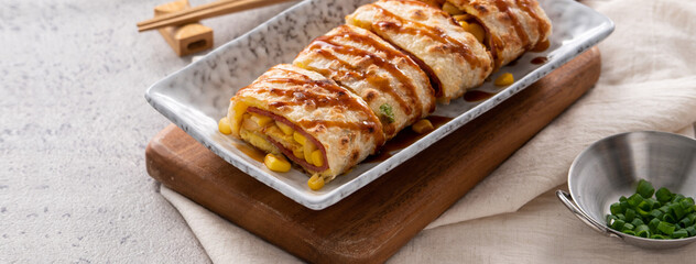 Delicious Taiwanese omelette, egg pancake roll with ham and corn kernels.