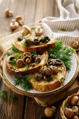 Toasts with cheese and mushrooms seasoned with herbs sprinkled with olive oil served on a plate, close up view