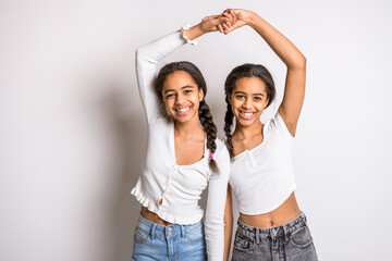 Adorable black twin teen girl on studio white background - obrazy, fototapety, plakaty
