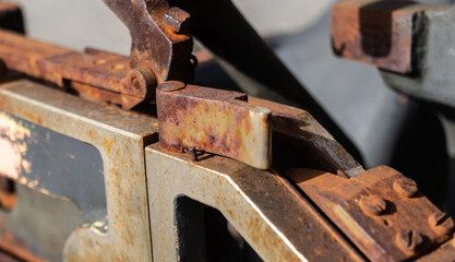 The detail of an old rusty mechanism. Rusty metal construction