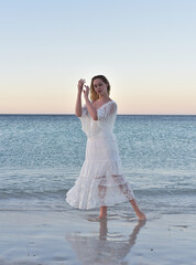 Fototapeta na wymiar Portrait of beautiful girl wearing flowing fantasy gown in a magical lake background.