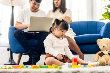 Portrait of enjoy happy love asian family father and mother with little asian girl smiling activity learn and skill brain training play with toy build wooden blocks board education game at home