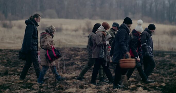 Ukrainian Refugees Walking In Forest During War Crisis.