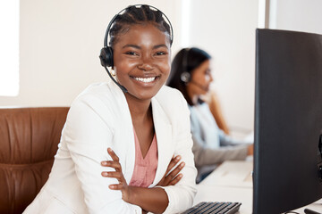 Im all ears to how I can help you. Portrait of a young call centre agent working in an office with her colleague in the background.