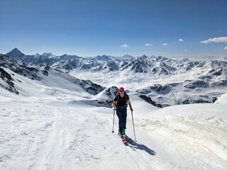 Fototapeta na wymiar a woman on a ski tour in a wonderful mountain landscape. Freedom and pure passion for ski mountaineering. Above the Fluelatal on the Gorihorn