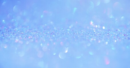 Bokeh light. Iridescent background. Underwater sequin reflection. Defocused pastel pink color shiny circles glare on blue glamour overlay.