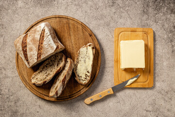 Loaf with dried fruits nuts and butter, top view