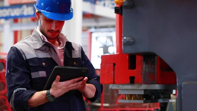 lathe and stamping metal machine. Hispanic man and Factory engineer in hard hat helmet working on digital teblet computer at Heavy Industry Manufacturing Factory.