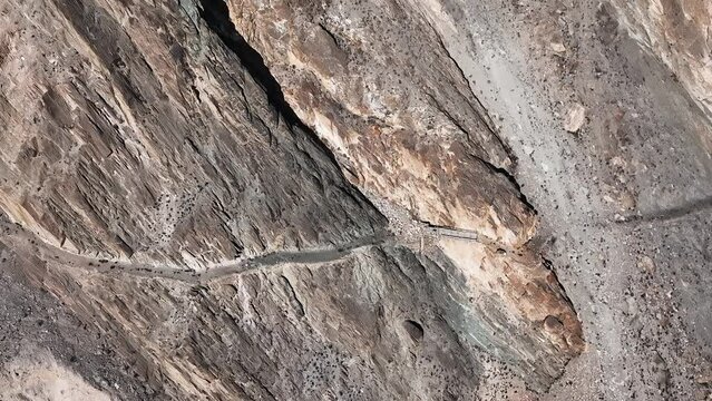 Car Driving On Winding Road Of Karakoram Near Khunjerab Pass In Pakistan. - aerial.  Dangerous road to Fairy Meadows and Nanga Parbat in Northern Pakistan