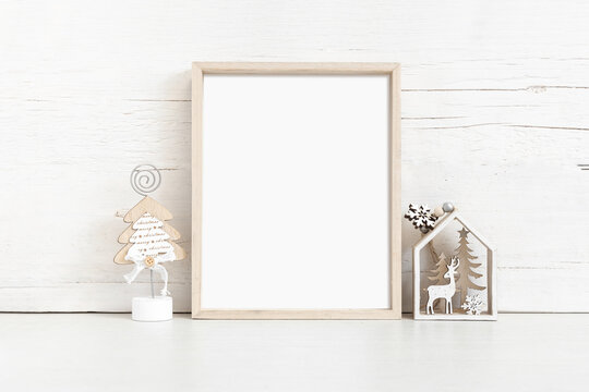 Vertical wooden frame mockup with christmas attributes.