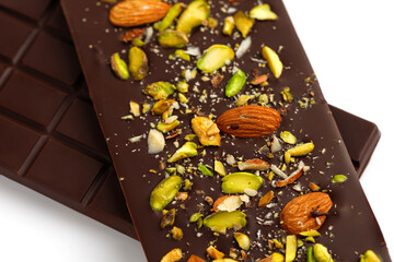 Homemade Chocolate bar with nuts, almond and pistachios isolated on a white. Two chocolate bars
