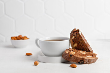 Italian chocolated cantucci with almond and hazelnuts. Biscotti cookies with nuts and cup of tea. Homemade biscotti. White background