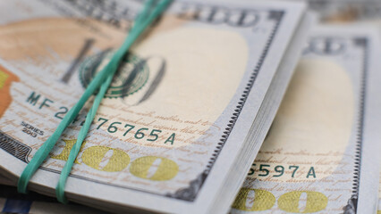 close-up of a stack of $ 100 bills of a new design. selective focus, macro photography