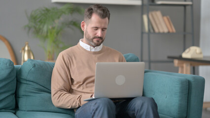 Man with Laptop Taking Nap on Sofa 