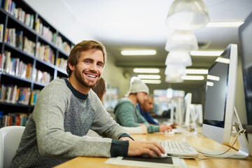 I work hard so that I can play hard. Cropped portrait of a young male university student studying in the library.