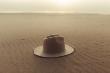 Fototapeta na wymiar beige hat on sand at beach