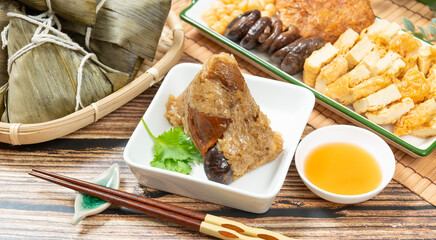 rice dumpling is a traditional Chinese rice dish made of glutinous rice and wrapped in bamboo leaves, Dragon Boat Festival is making and eating zongzi with family