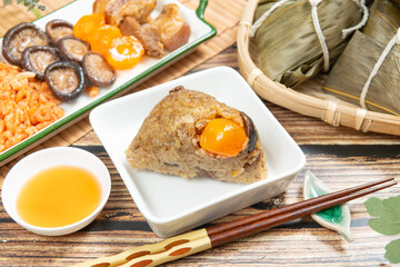 rice dumpling is a traditional Chinese rice dish made of glutinous rice and wrapped in bamboo leaves, Dragon Boat Festival is making and eating zongzi with family