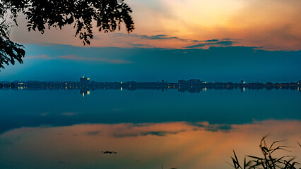 Fototapeta na wymiar Sunset with a beautiful sky in the golden hour at Hussain Sagar Lake in Hyderabad, Telangana, India
