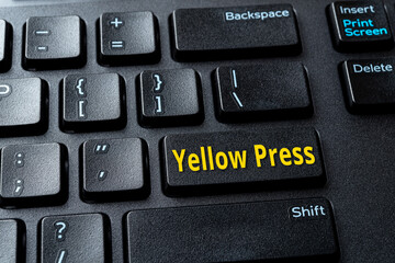 Yellow Press enter key on the black pc keyboard. Concept of disinformation, lies and hoax in the...