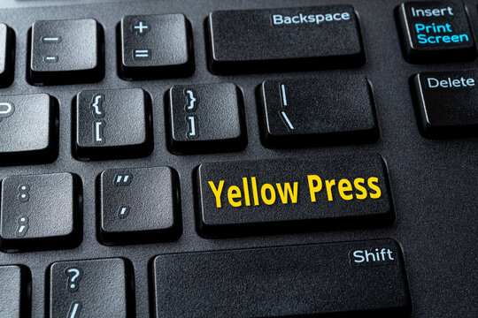Yellow Press enter key on the black pc keyboard. Concept of disinformation, lies and hoax in the media. Spread false information on the Internet. Computer enter key with word message.