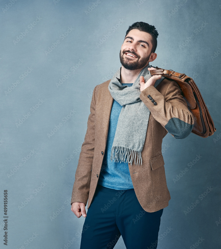 Poster style doesnt compete because its unique. studio shot of a stylishly dressed young man posing against