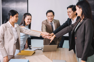 Selective focus on hands. Group business team showing unity and power with their hand's success together at the office.