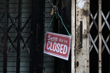 The metal door of a shop with the words sign 