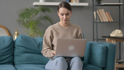 Woman Working on Laptop on Sofa 