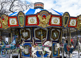 Vintage carousel merry-go-round ride in the city amusement park