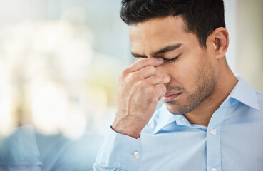 Sometimes challenges arise last minute. Shot of a businessman experiencing a headache at work.