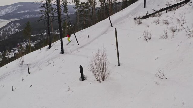 Drone shot of man freeriding in the mountains on skis.