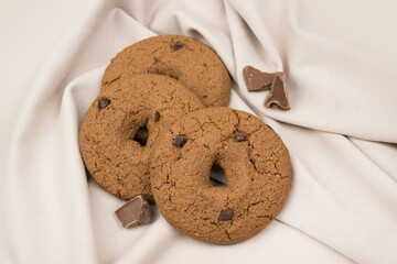 Natural oatmeal cookies with chocolate chips. A beautiful dark cookie lies with spikelets