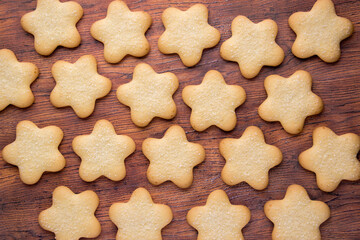 Cookies with sugar in the shape of an asterisk. A lot of Christmas cookies are lying and sprinkled with sugar