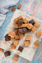 Chocolate caramel lies beautifully in pieces. Sweet toffee with nuts and cocoa