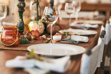 Ready to serve lunch. Shot of a nicely set diner table with different kinds of plates and glasses on it.