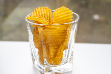 Chips. Chips in a glass. Chips in a bowl of bokeh. Chips with blurred background