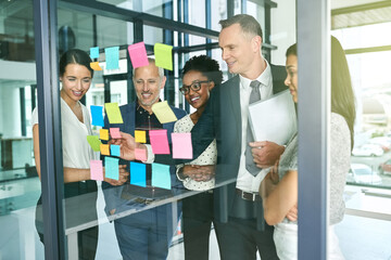 Putting their heads together. Cropped shot of three businesswoman strategising in their office.