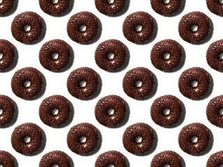 Seamless pattern made with chocolate doughnuts on the white background. Trendy minimal summer concept.