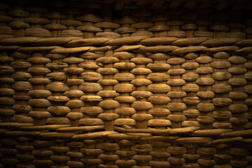 Photo of the texture of a wicker basket. Vintage weaving of straw grass on the wall of furniture. Natural braided background for text.