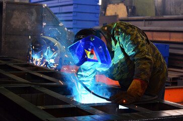 the welder at the factory cooks the structure