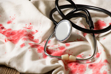 White dress in the blood and a stethoscope, treatment and medicine, blood stains on the scales