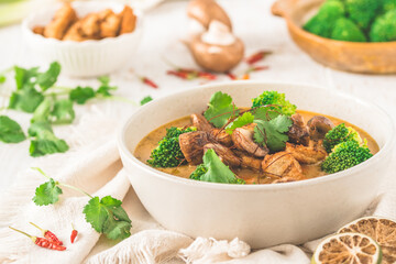 Vegan Tom Kha Gai soup with various vegetables and roasted soy-based meat substitutes
