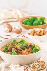 Vegan Tom Kha Gai soup with various vegetables and roasted soy-based meat substitutes