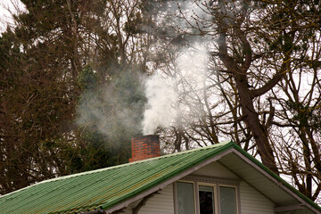 Smoke from the chimney. Heating with wood. Furnace heating of the building.
