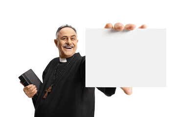 Priest showing a blank card and holding a bible