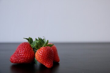 Three fresh strawberries isolated on a table