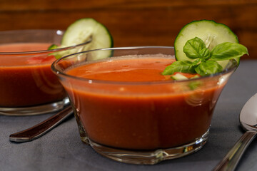 High view of a Transparent glass bowl with Gaspacho Andaluz. A vegetable and organic soup or cold drink that is drunk in summer or hot days.