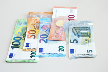 Set of Euro banknotes on a light background. EU money of various denominations. Banking concept, currency exchange, inflation.